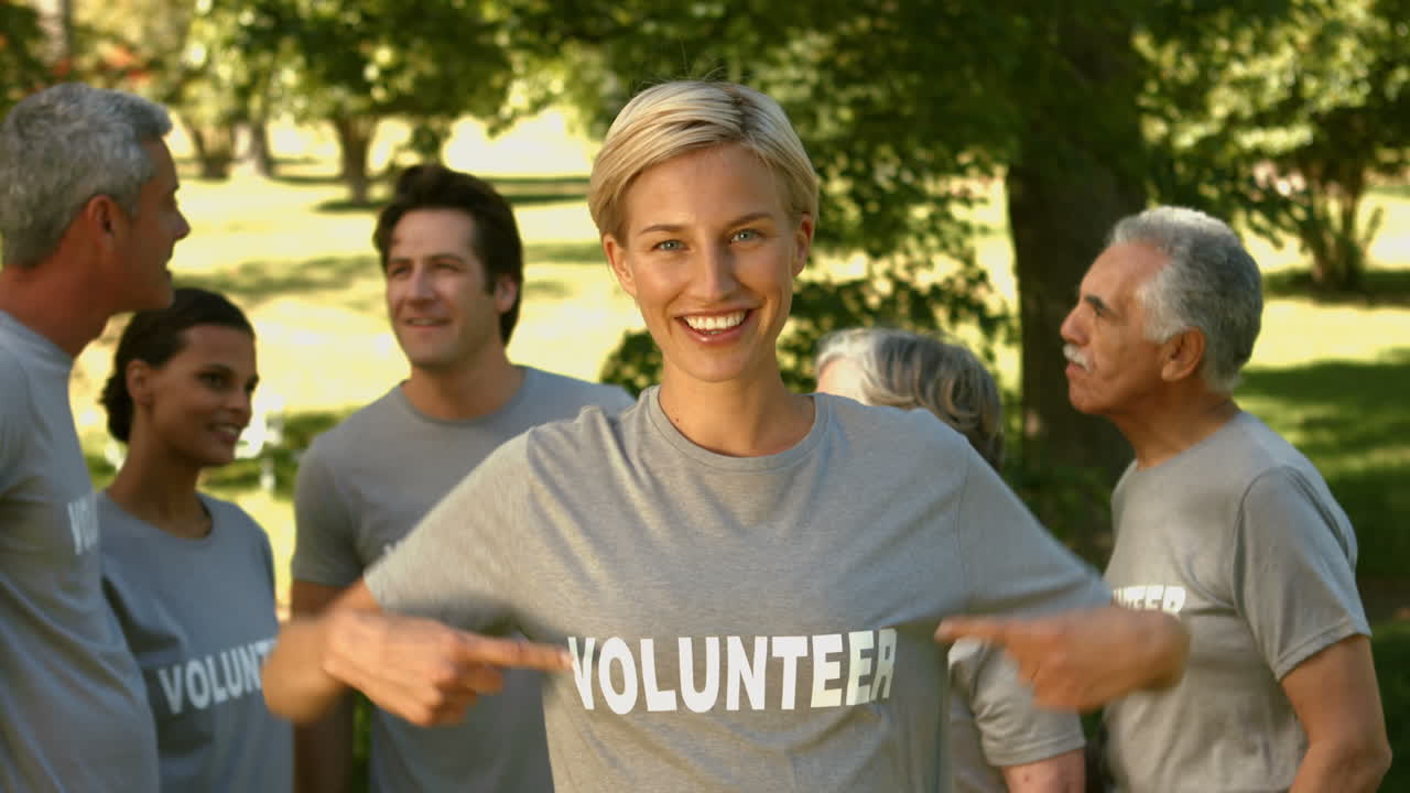 Team of happy volunteers in the park