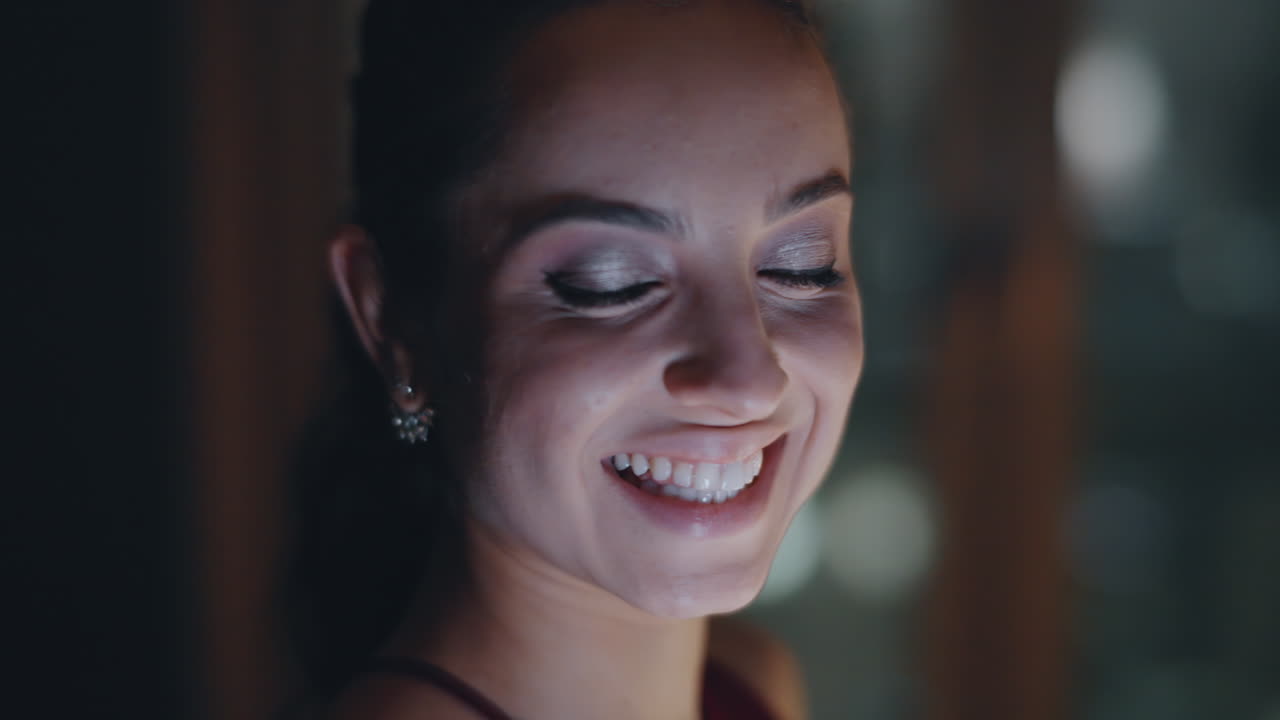 Pensive woman looking window using smartphone in night cityscape flat closeup