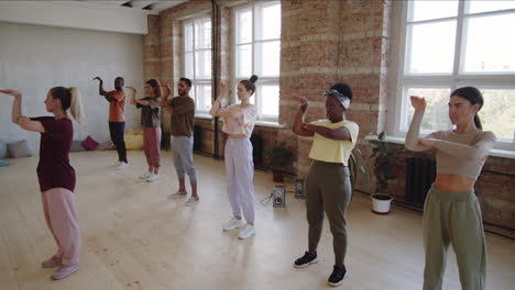 dance teacher explaining choreography to diverse students