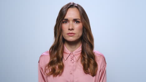 serious businesswoman waving head no at camera. upset woman standing in studio