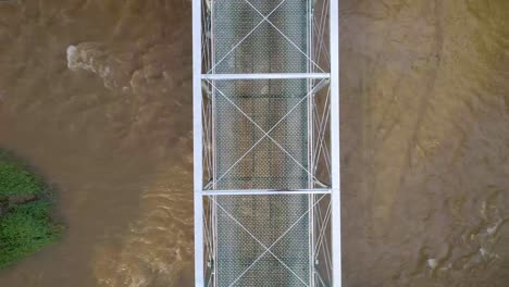 Aerial shot of a bridge over top of a river