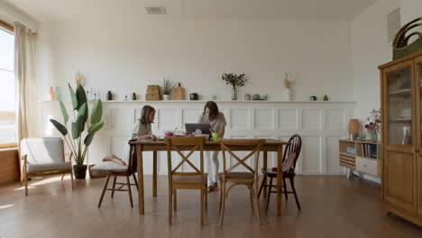 Wide-Shot-Of-A-Blonde-Cute-Girl-Doing-Her-Homework-In-Her-Living-Room