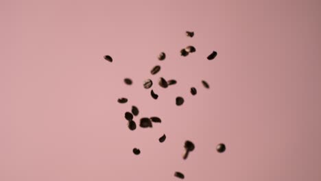 Coffee-beans-falling-with-a-pink-background