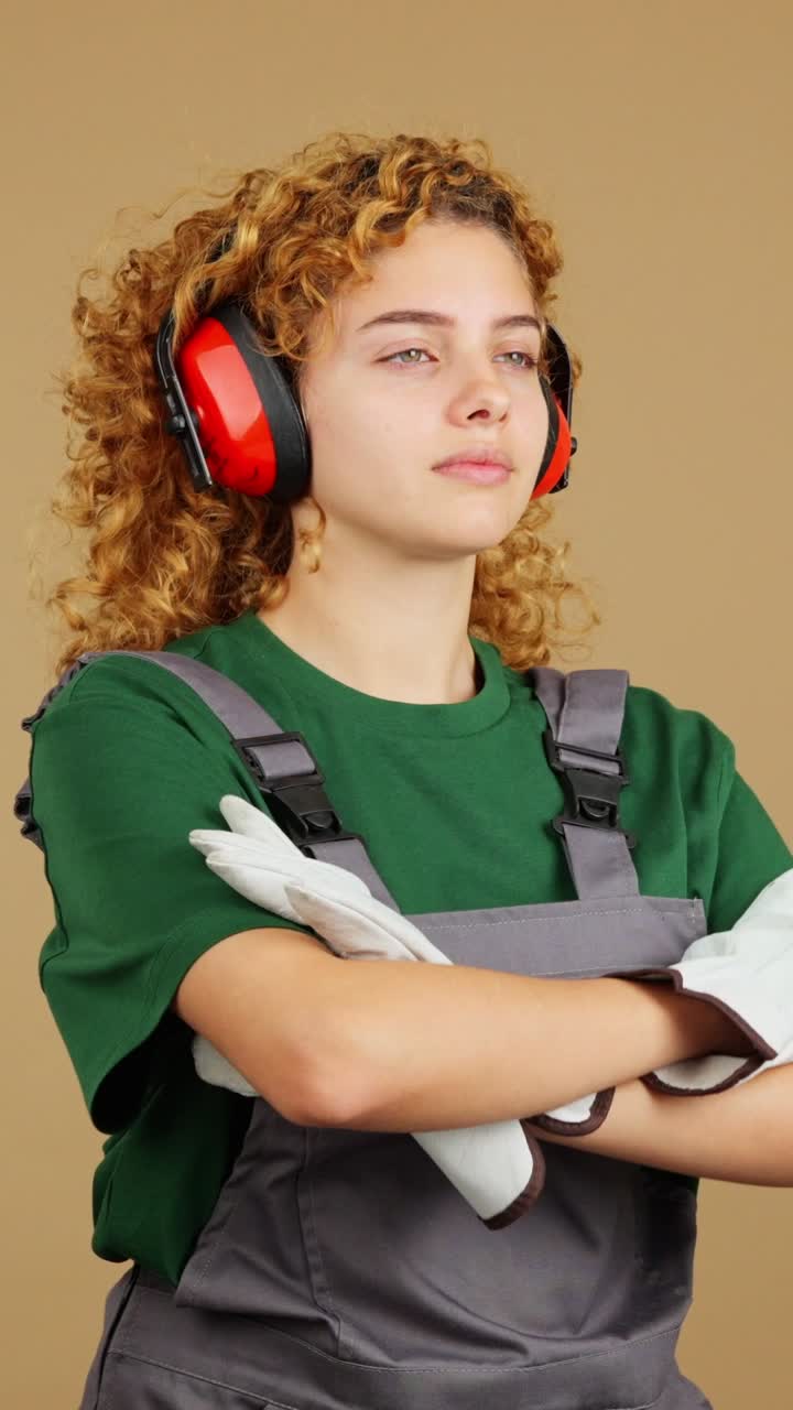 Young Woman Worker with Curly Hair Wearing Safety Gear