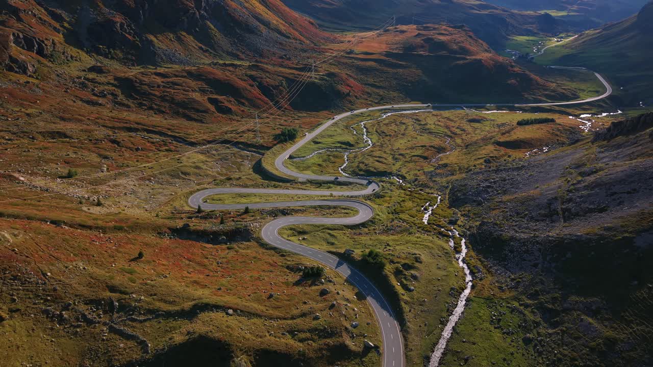 Aerial view showing Julier Pass mountain landscape with a captivating winding road and stream