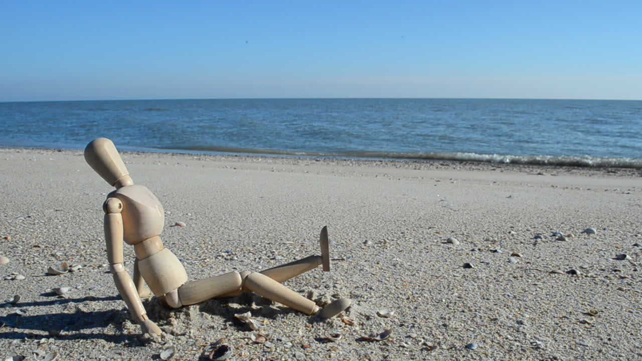 Wooden dummy on the beach. Shooting on the beach