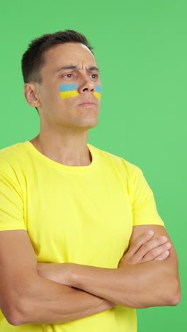 Ukrainian patriot man looking away with serious expression