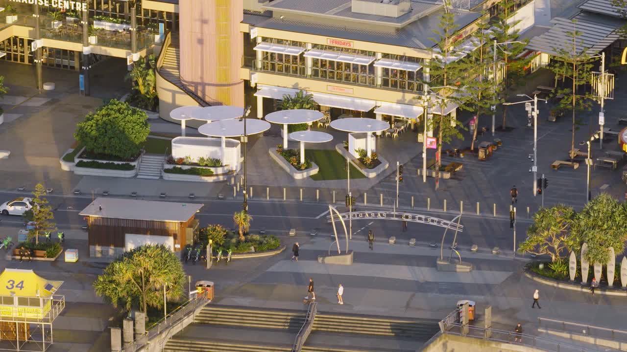 Aerial view of people strolling along Cavill Avenue at sunrise, capturing the vibrant morning atmosphere of Surfers Paradise