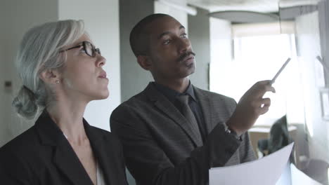 male mentor teaching new female employee