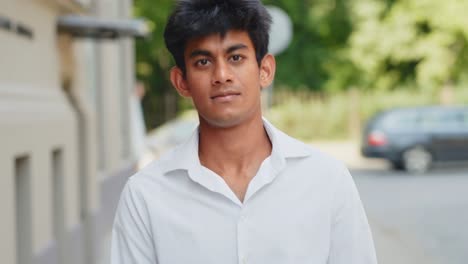 confident manager in white buttoned shirt walks towards camera in slow motion