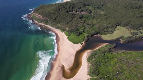 glenrock lagoon and beach in new south wales, australia - drone shot