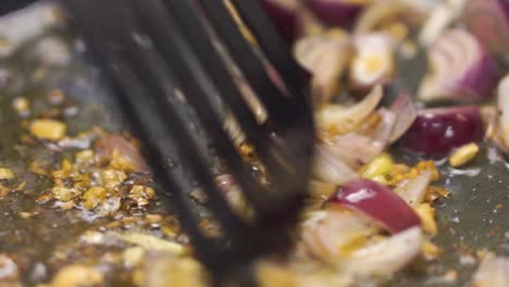 frying onions and garlic in a pan