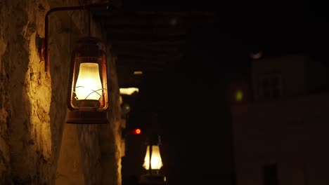vintage lanterns on stone wall at night