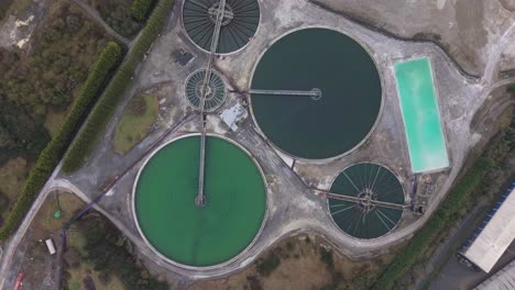 overhead view of clarifier tanks at industrial plant of magnesium oxide and magnesium hydroxide in ireland. - aerial shot