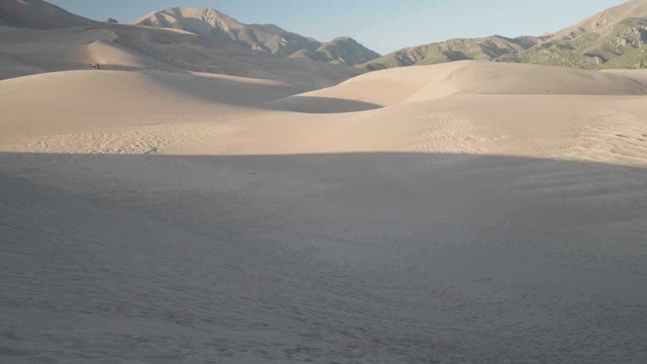 Sand dunes landscape with mountains