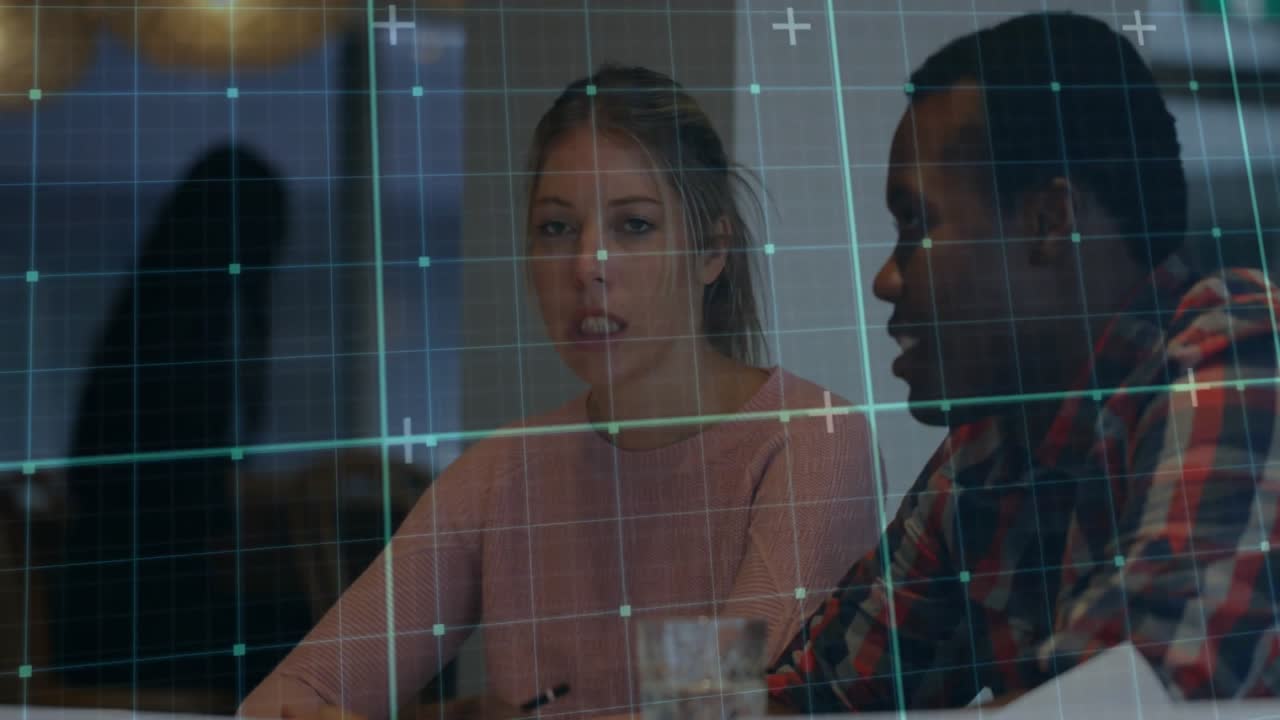 Woman lowering pen and initiating tech meeting as peer shifting documents under clear grid display