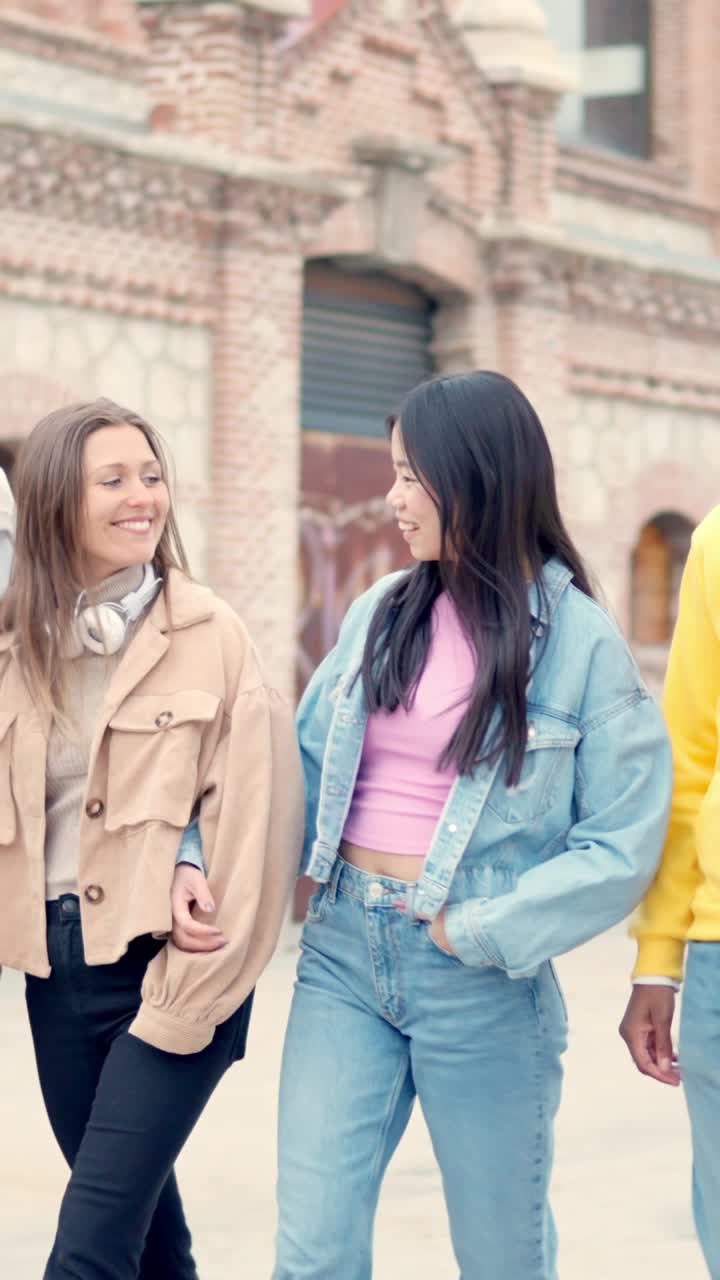 Multiethnic lesbian couple walking on the street