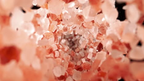 himalayan pink salt is fallingin a super slow motion. pink himalayan salt is up to twenty times more expensive than table or sea salt. shot on super slow motion camera 1000 fps.