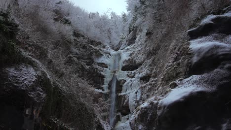 clip of a frozen waterfall filmed in europe in austria from a town called hallstatt