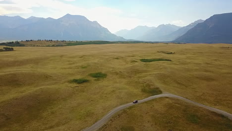 Aerial:-Hilly-ancient-glacial-moraine-in-flat-mountain-valley,-Canada