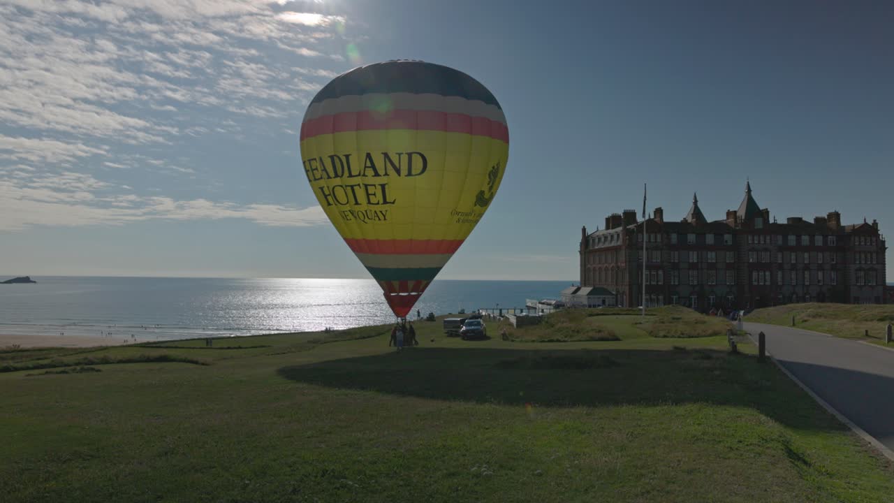 Close-up shot of the Headland Hotel with a branded advertising hot air balloon