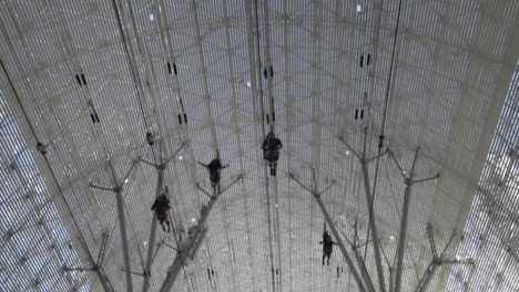 four people flying past on the slotzilla zip line over fremont street experience, las vegas