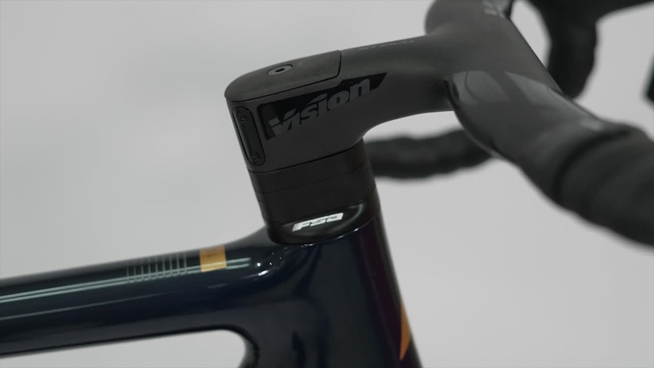 Close-up of bicycle handlebars and stem with Vision and FSA components