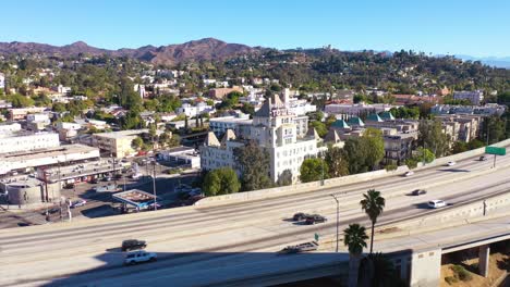 aerial of the hollywood tower hotel with the hollywood freeway foreground and hollywood hills background