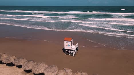 Discover-the-tranquility-of-this-stunning-sandy-beach,-captured-in-4K-with-smooth-drone-footage-panning-right-to-felt