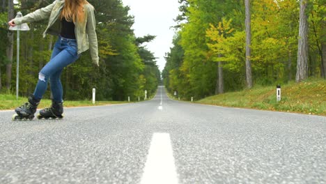 young girl with inline skates on the street, having fun