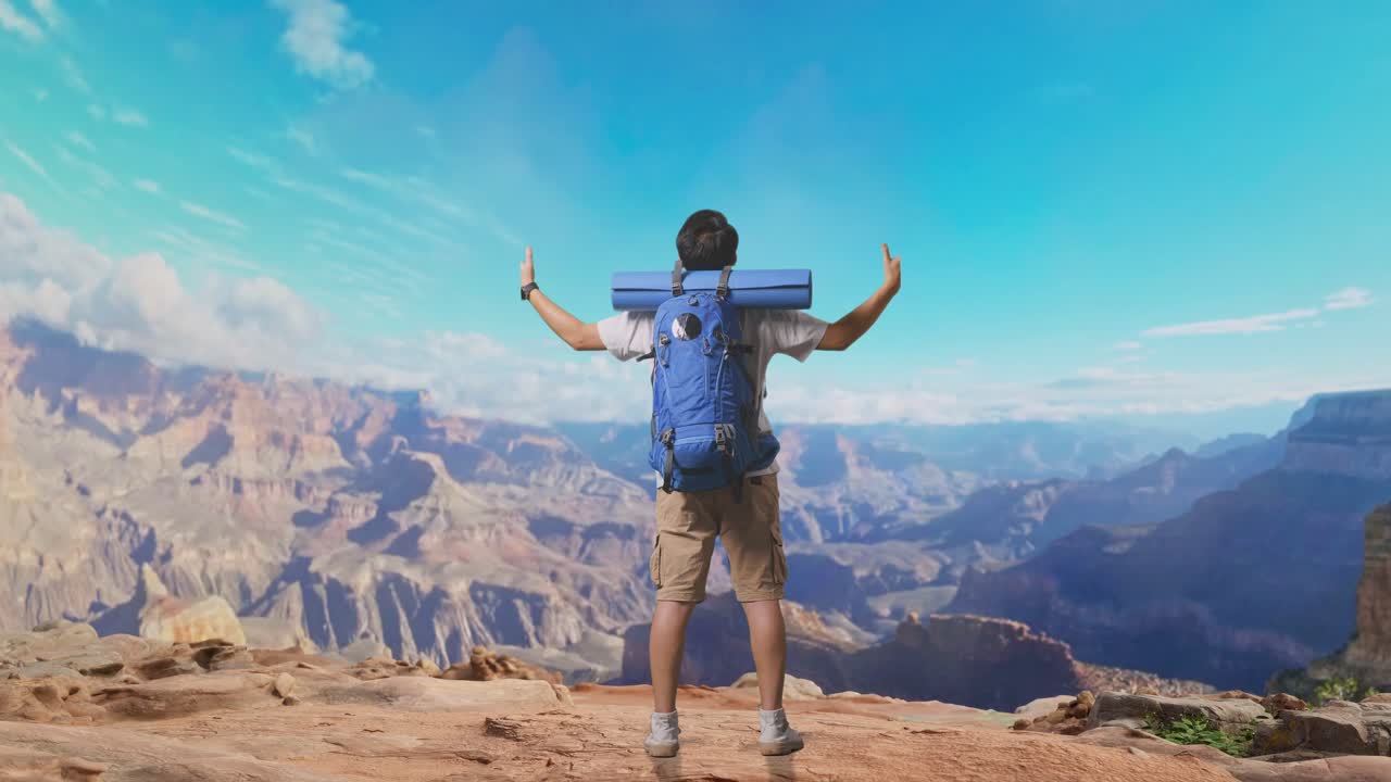 Full Body Back View Of A Male Hiker With Mountaineering Backpack Spreading Arms And Looking The View Around While Traveling At The Top Of Mountain