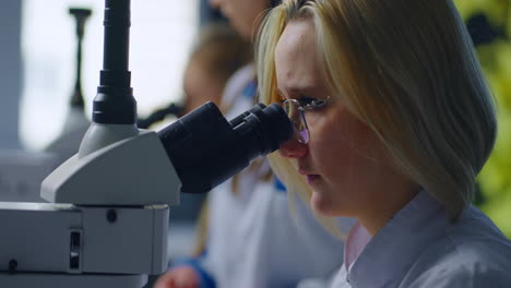 scientist using a microscope