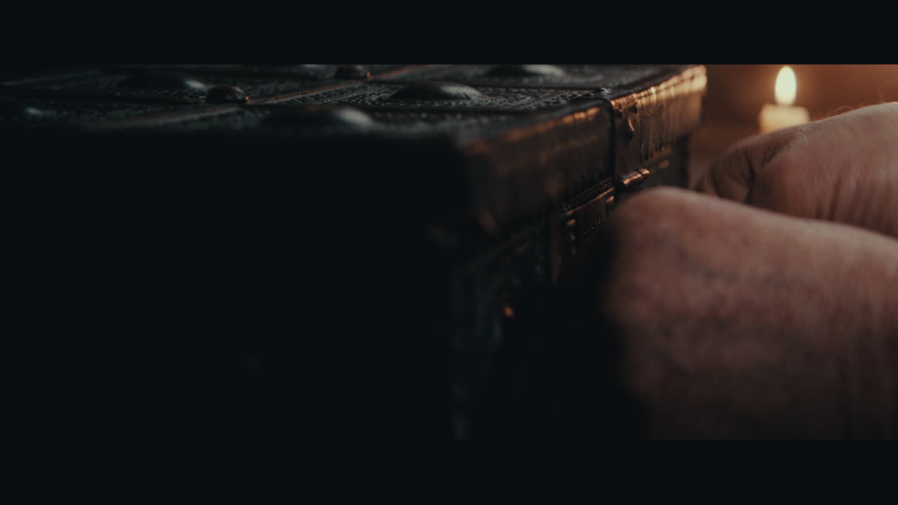 An old captain opens an old document chest inside the sailing ship cabin