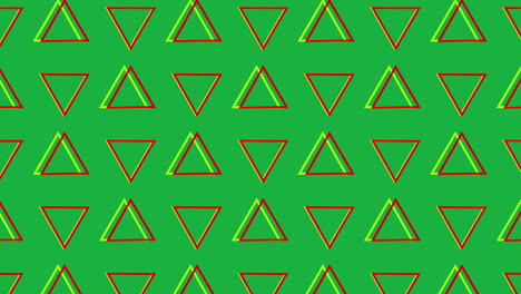 triángulos giratorios en formación sobre un fondo verde