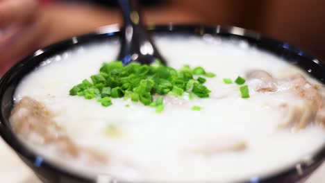 rice porridge garnished with fresh green onions