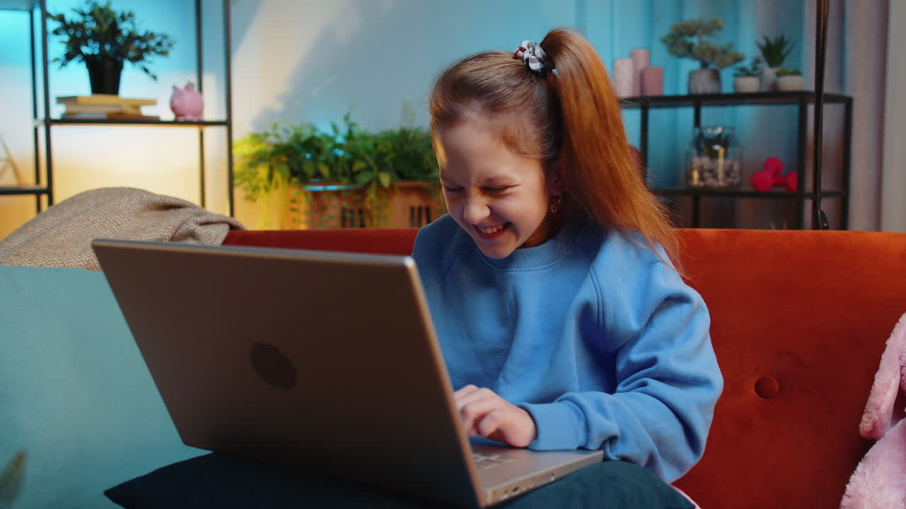 Amazed teen girl use laptop computer play game celebrate win victory receive good news message