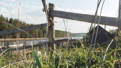 rustic countryside scene with wooden structures by a river