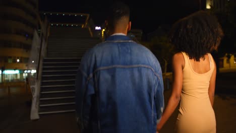 couple walking together hand in hand in city street 4k