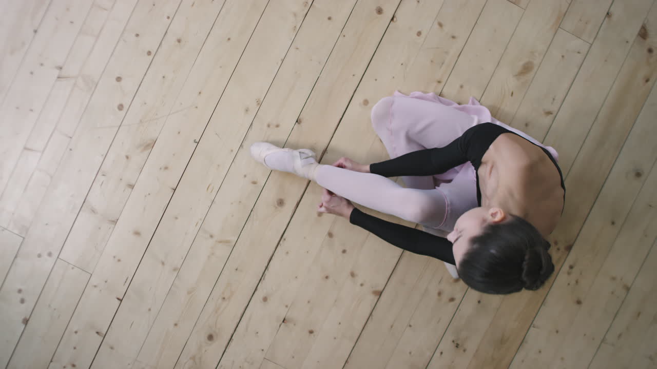 Top View Of Young Ballerina Wearing Pointe Shoes