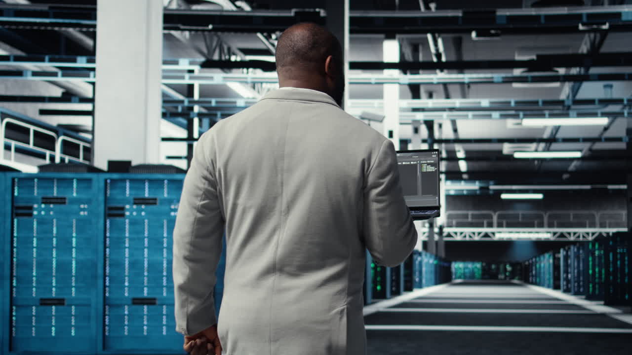 Vertical video Data center technician using laptop to manage software updates