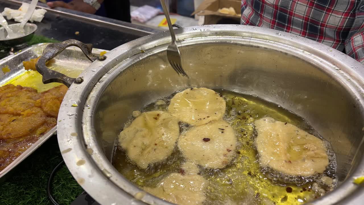 Frying of malpua on hot oil. Indian sweets.