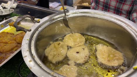 frying of malpua on hot oil. indian sweets.