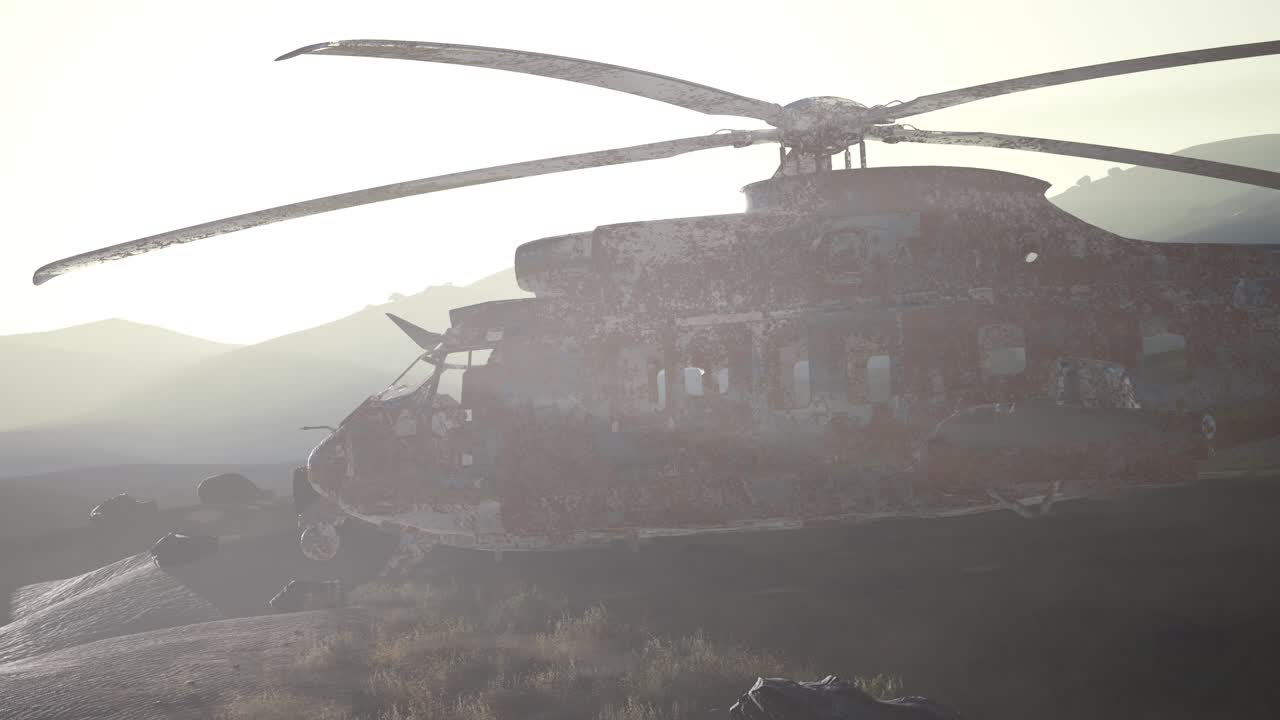 old rusted military helicopter in the desert at sunset