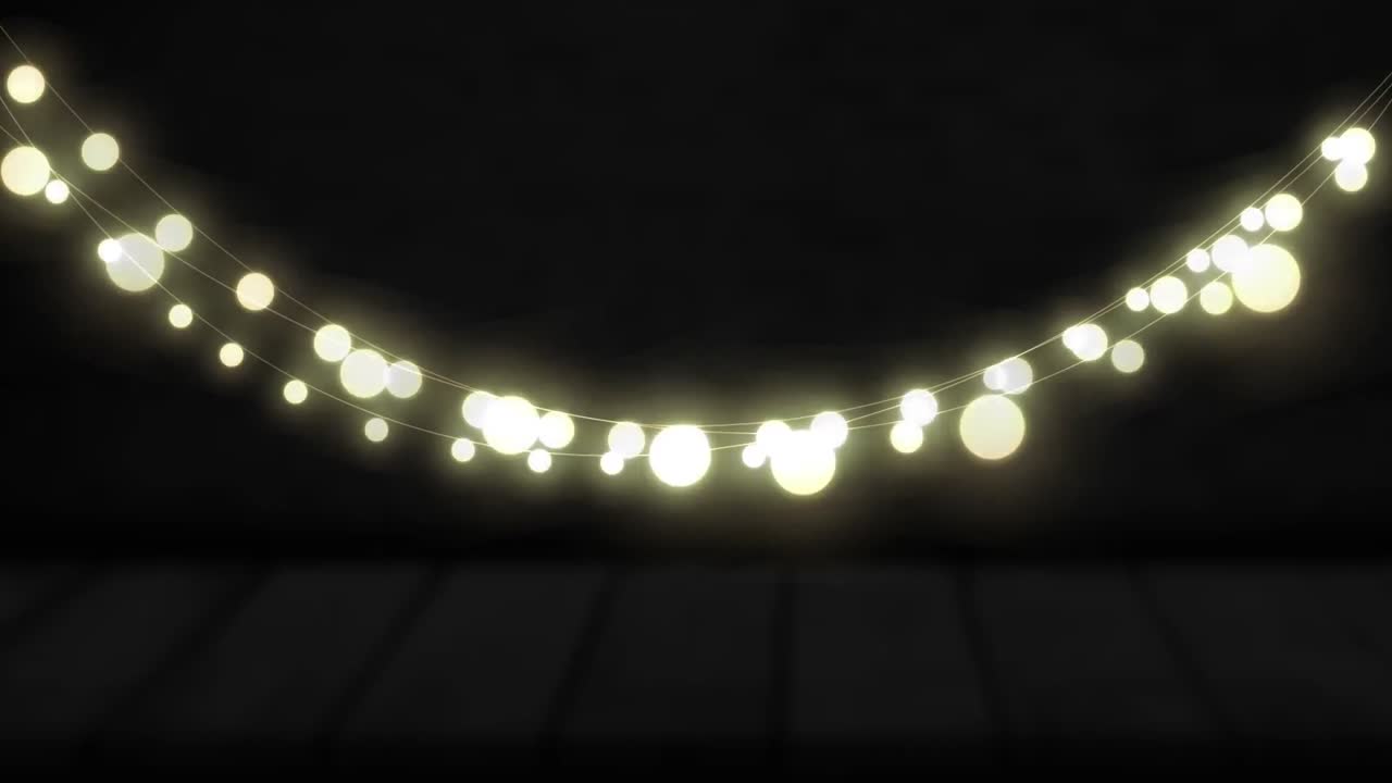 Animation of yellow round shaped glowing fairy lights hanging against copy space on black background