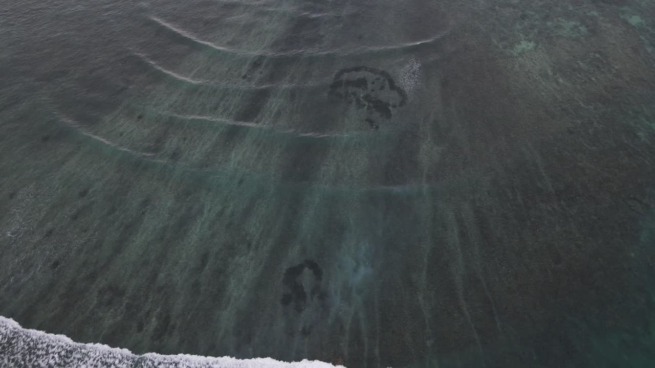 Aerial View of Ocean Waves Breaking Over a Shallow Reef