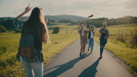 woman filming friends having fun on footpath