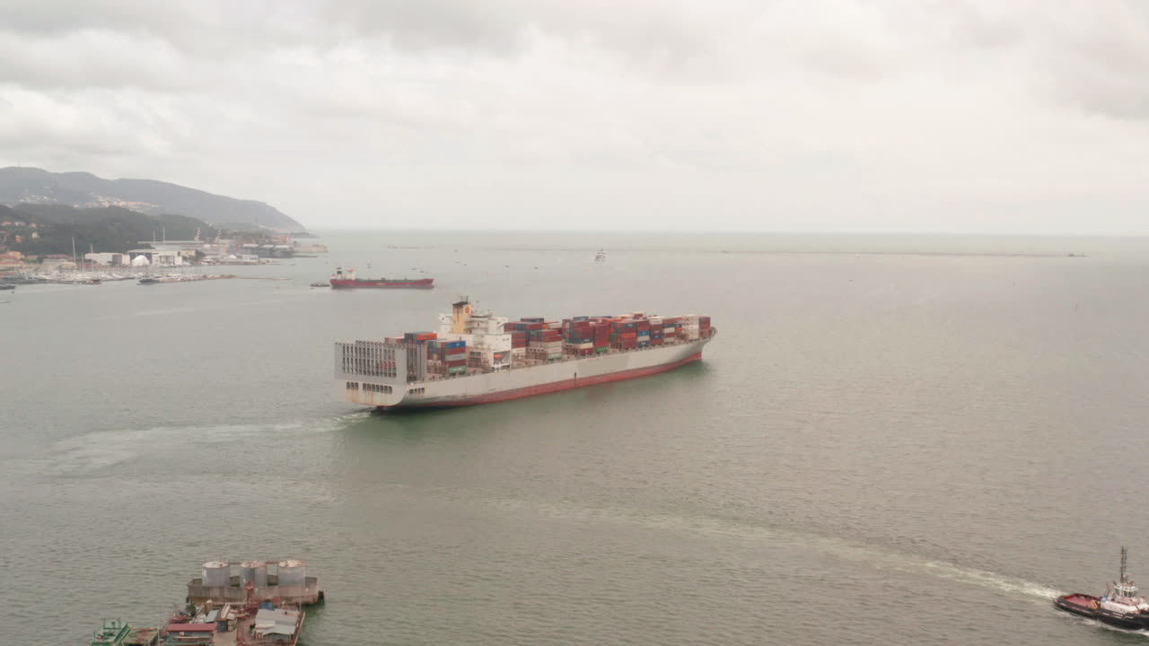 Aerial of large container ship leaving harbor