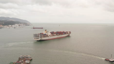 aerial of large container ship leaving harbor