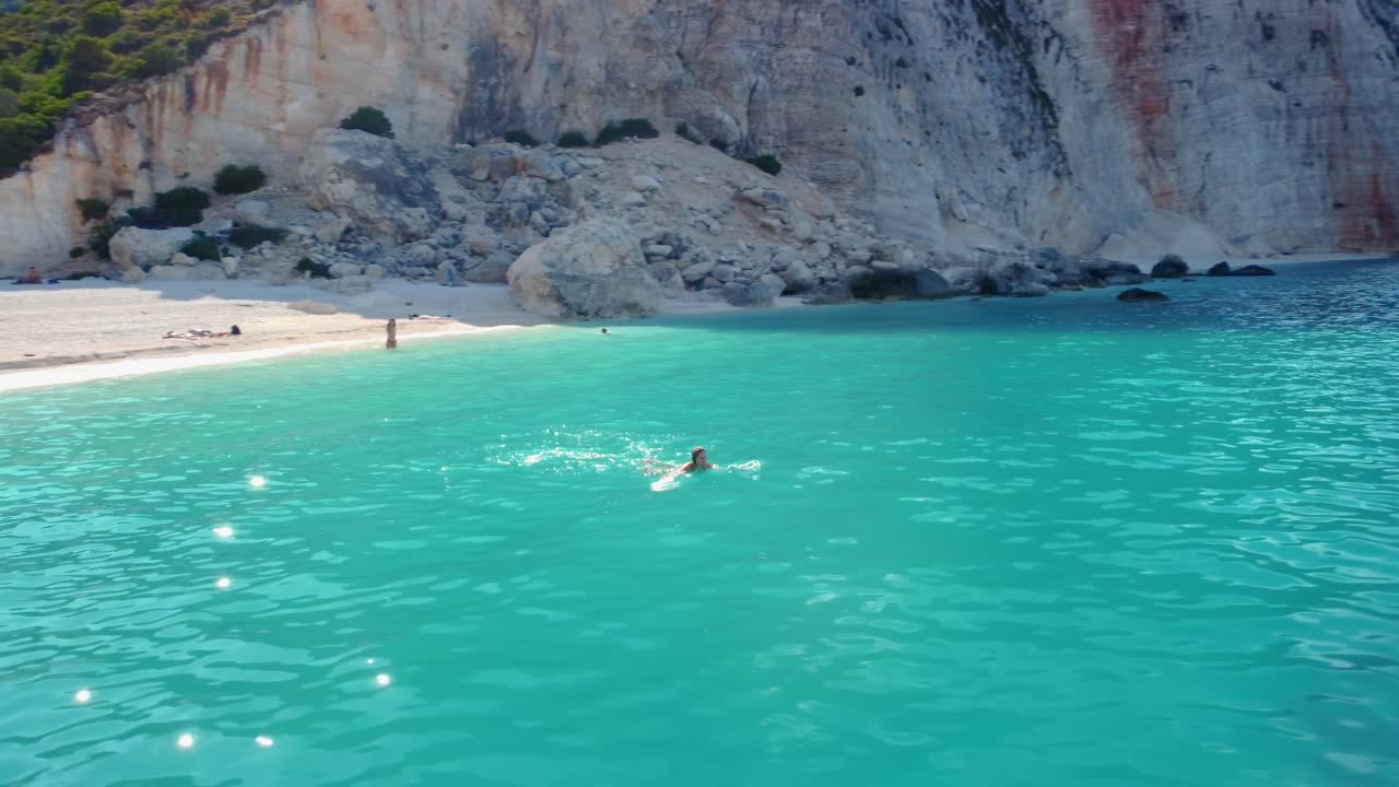 Woman swimming in sea near Fteri beach in Kefalonia Island, Greece