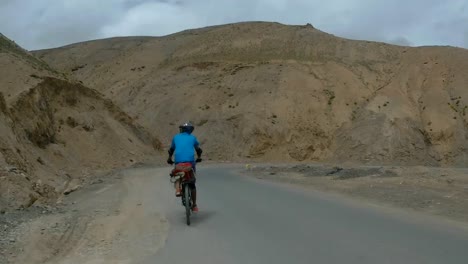 biker speeding on the mountain road to leh in ladakh, india - rolling shot